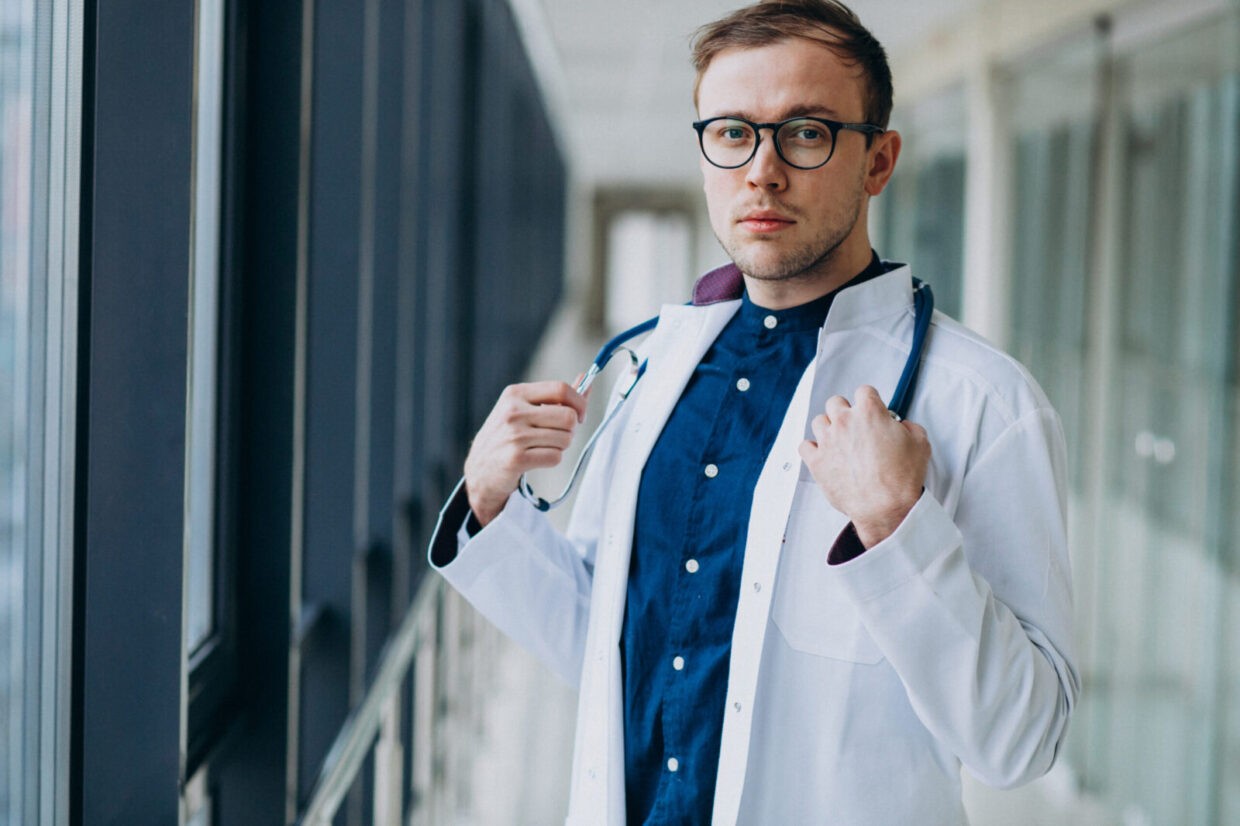 young handsome doctor with stethoscope at clinic